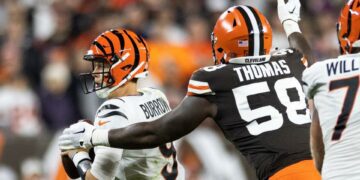 Oct 31, 2022; Cleveland, Ohio, USA; Cleveland Browns defensive end Isaiah Thomas (58) sacks Cincinnati Bengals quarterback Joe Burrow (9) during the second quarter at FirstEnergy Stadium. Mandatory Credit: Scott Galvin-USA TODAY Sports