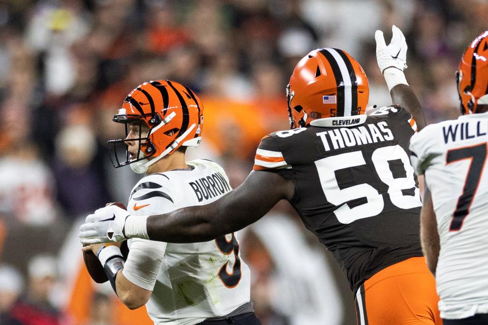 Oct 31, 2022; Cleveland, Ohio, USA; Cleveland Browns defensive end Isaiah Thomas (58) sacks Cincinnati Bengals quarterback Joe Burrow (9) during the second quarter at FirstEnergy Stadium. Mandatory Credit: Scott Galvin-USA TODAY Sports