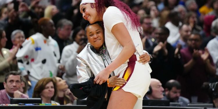 Apr 7, 2024; Cleveland, OH, USA; South Carolina Gamecocks center Kamilla Cardoso (10) embraces head coach Dawn Staley in the fourth quarter against the Iowa Hawkeyes in the finals of the Final Four of the womens 2024 NCAA Tournament at Rocket Mortgage FieldHouse. Mandatory Credit: Kirby Lee-USA TODAY Sports ORG XMIT: IMAGN-742941 ORIG FILE ID: 20240407_lbm_al2_142.JPG