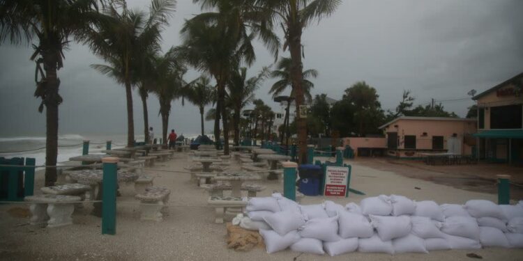 Sandbags are lined up near Bonita Beach in Bonita Springs, Florida, on Sunday, August 4, 2024. - Andrew West/The News-Press/USA Today Network