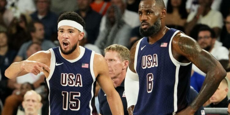 Aug 10, 2024; Paris, France; United States guard Devin Booker (15) and United States guard Lebron James (6) in the men's basketball gold medal game during the Paris 2024 Olympic Summer Games at Accor Arena. Mandatory Credit: Rob Schumacher-USA TODAY Sports