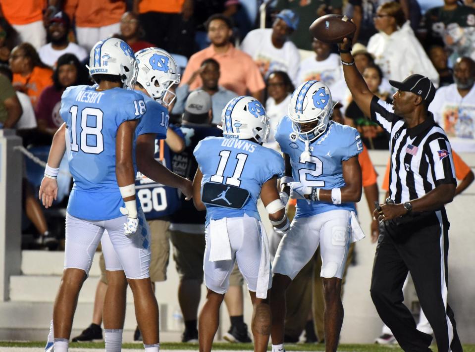 Aug 27, 2022; Chapel Hill, North Carolina, USA; North Carolina Tar Heels receiver Gavin Blackwell (2) is greeted by teammates after scoring a touchdown during the first half against the Florida A&M Rattlers at Kenan Memorial Stadium. Mandatory Credit: Rob Kinnan-USA TODAY Sports