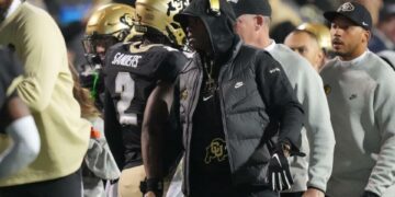 Oct 13, 2023; Boulder, Colorado, USA; Colorado Buffaloes head coach Deion Sanders congratulates his son quarterback Shedeur Sanders (2) following a touchdown throw in the first quarter against the Stanford Cardinal at Folsom Field. Mandatory Credit: Ron Chenoy-USA TODAY Sports