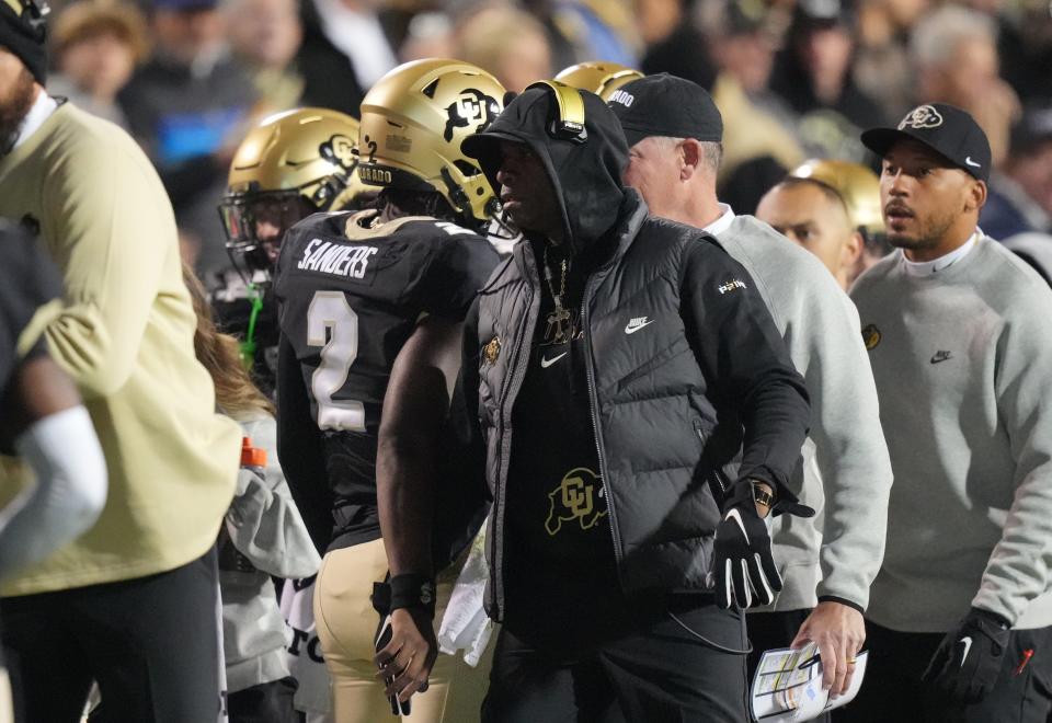 Oct 13, 2023; Boulder, Colorado, USA; Colorado Buffaloes head coach Deion Sanders congratulates his son quarterback Shedeur Sanders (2) following a touchdown throw in the first quarter against the Stanford Cardinal at Folsom Field. Mandatory Credit: Ron Chenoy-USA TODAY Sports