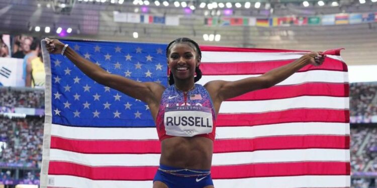 Masai Russell celebrates winning the women’s 100-meter hurdles at the Paris Olympic Games.