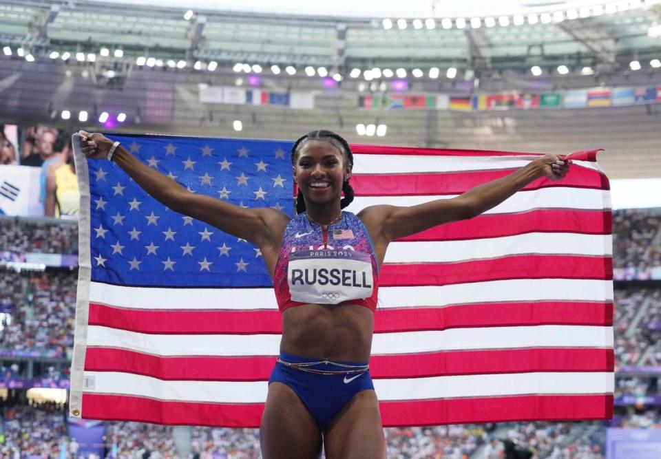 Masai Russell celebrates winning the women’s 100-meter hurdles at the Paris Olympic Games.