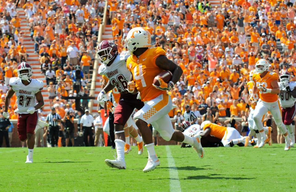 Sep 23, 2017; Knoxville, TN, USA; Tennessee Volunteers running back John Kelly (4) carries the ball for a touchdown against the Massachusetts Minutemen during the second quarter at Neyland Stadium. Mandatory Credit: Randy Sartin-USA TODAY Sports