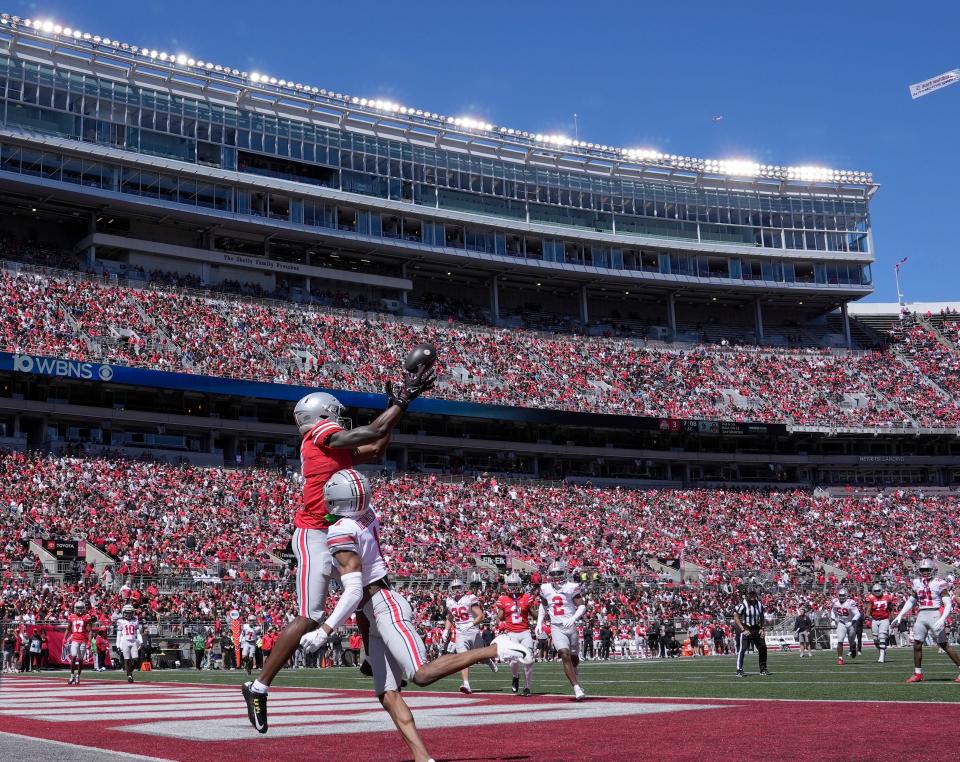 April 13, 2024; Columbus, Ohio, USA; 
Ohio State Buckeyes wide receiver Jeremiah Smith (4) playing for the scarlet team can't reel in a pass while defended by cornerback Davison Igbinosun (1) of the gray team of the during the first half of the LifeSports Spring Game at Ohio Stadium on Saturday. Despite the Spring Game being televised for the first time there were still plenty of fans in the stands at Ohio Stadium.