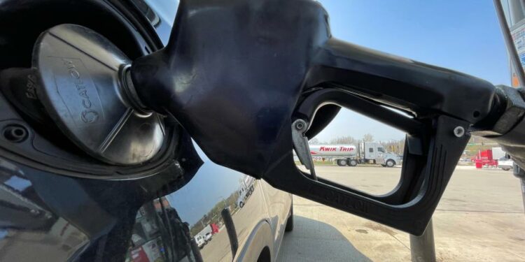 A customer fuels a car Tuesday, May 10, 2022 at Kwik Trip, 2900 Holy Hill Rd. in Richfield, Wis.