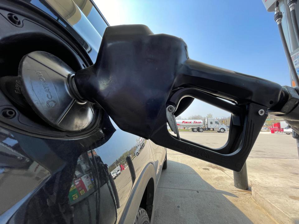 A customer fuels a car Tuesday, May 10, 2022 at Kwik Trip, 2900 Holy Hill Rd. in Richfield, Wis.