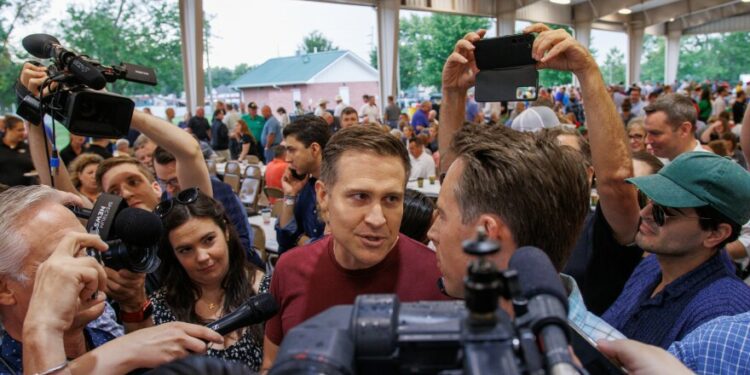 Lucas Kunce, left, and Josh Hawley, right, confront each other at the Governor’s Ham Breakfast starts in Sedalia on Thursday, August 15, 2024.