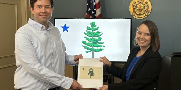 Adam Lemire of Gardiner was selected Monday as the winner of the Maine State Flag Redesign Contest. Lemire is pictured with Maine Secretary of State Shenna Bellows.