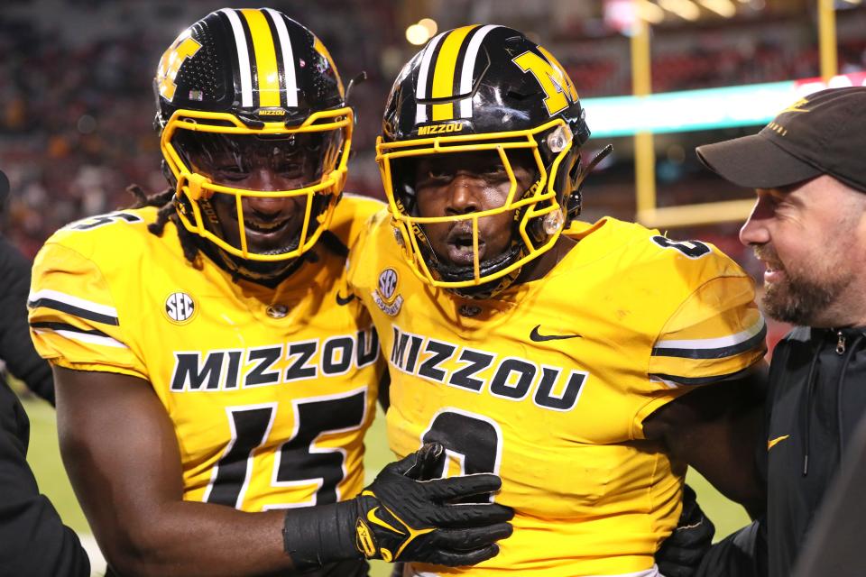 Nov 24, 2023; Fayetteville, Arkansas, USA; Missouri Tigers defensive lineman Johnny Walker Jr (15) and Jay Jernigan celebrate after a defensive touchdown by Jernigan in the third quarter against the Arkansas Razorbacks at Donald W. Reynolds Razorback Stadium. Missouri won 48-14. Mandatory Credit: Nelson Chenault-USA TODAY Sports ORG XMIT: IMAGN-712572 ORIG FILE ID: 20231124_jad_sc6_383.JPG