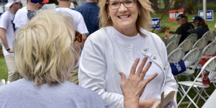 Illinois GOP Chair Kathy Salvi speaks to a supporter Thursday at Republican Day at the Illinois State Fair.