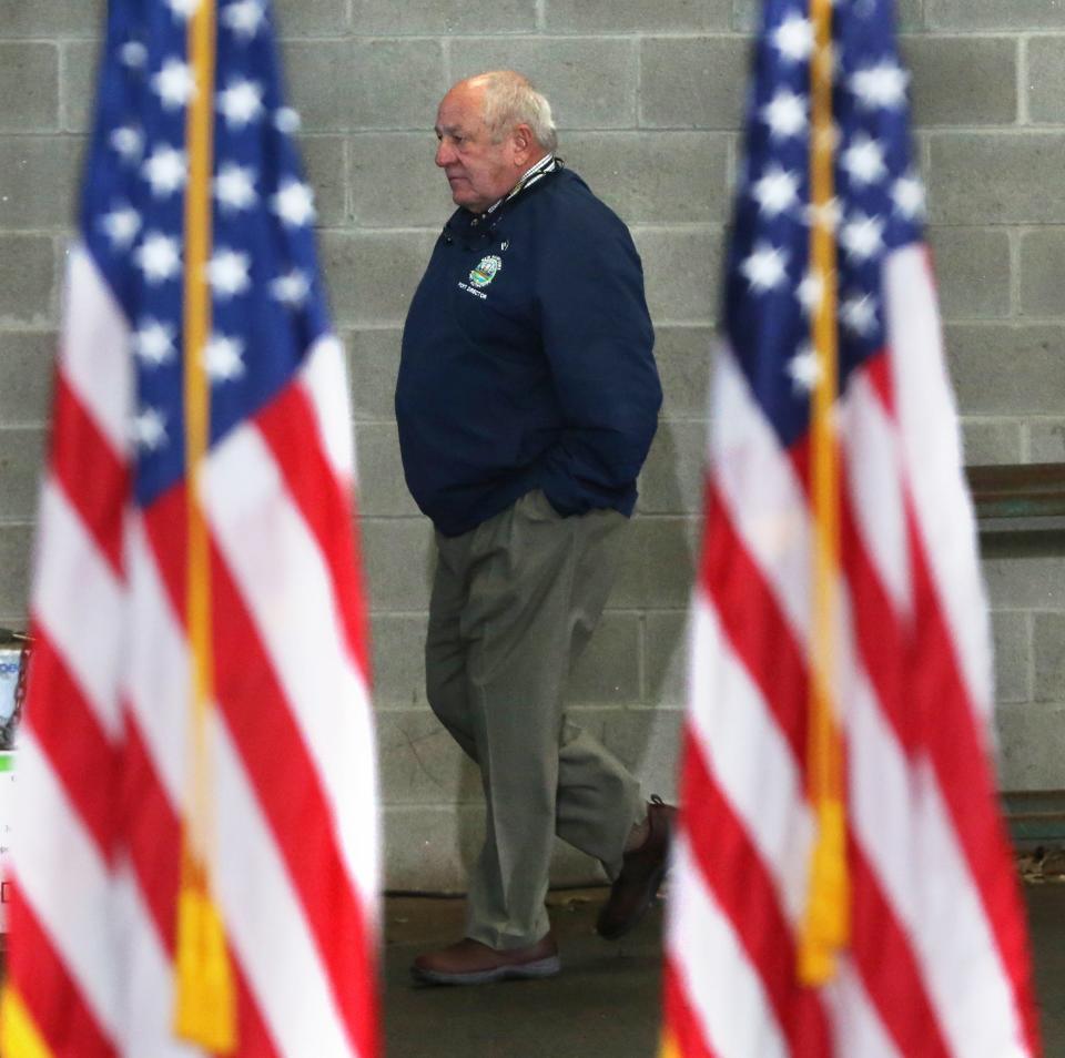 Geno Marconi walks between American flags during President Joe Biden's visit to the New Hampshire Port Authority in Porstmouth April 19, 2022.