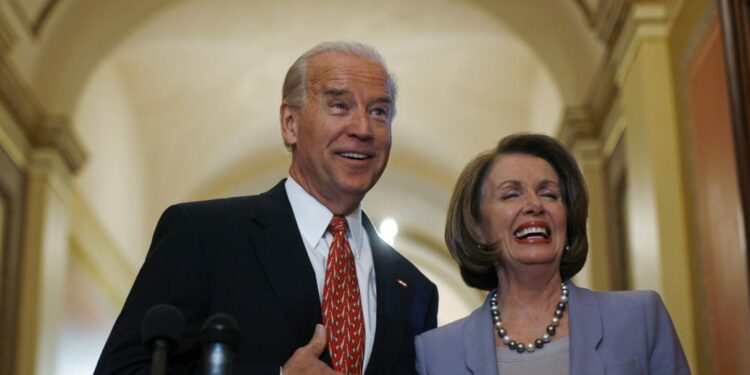 Joe Biden and Nancy Pelosi laugh together in old photo.