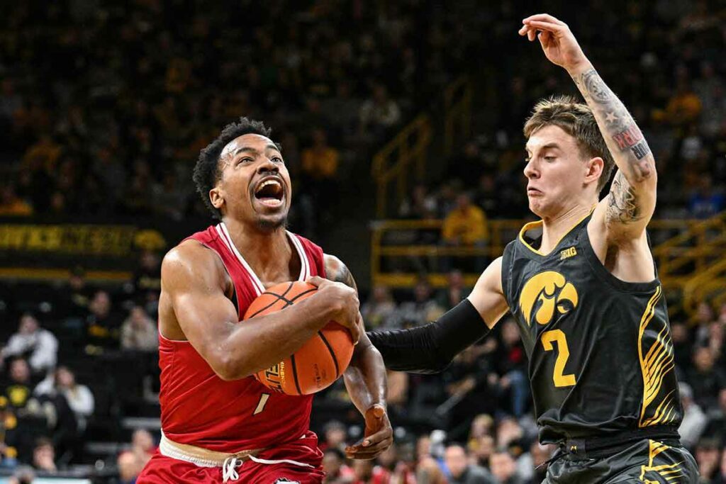 Northern Illinois Huskies guard David Coit (11) goes to the basket as Iowa Hawkeyes guard Brock Harding (2) defends during the first half at Carver-Hawkeye Arena.