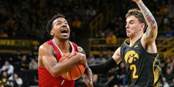 Northern Illinois Huskies guard David Coit (11) goes to the basket as Iowa Hawkeyes guard Brock Harding (2) defends during the first half at Carver-Hawkeye Arena.