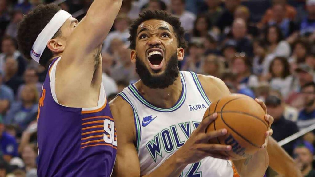 Minnesota Timberwolves forward Karl-Anthony Towns (32) works around Phoenix Suns guard Devin Booker (1) in the third quarter at Target Center.