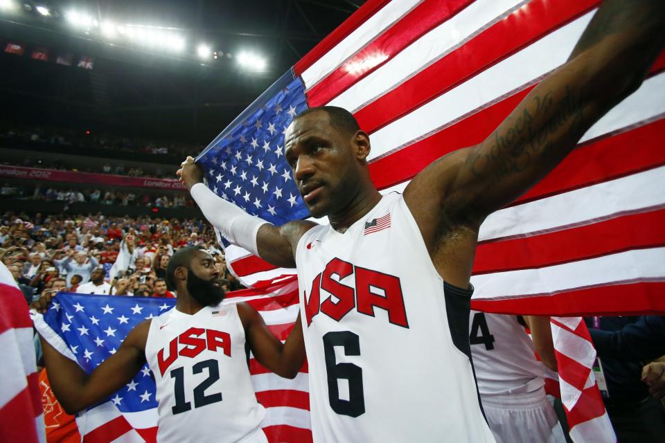 Aug 12, 2012; London, United Kingdom; USA forward LeBron James (6) and guard James Harden (12) celebrate with American flags after defeating Spain 107-100 in the men's basketball gold medal game in the London 2012 Olympic Games at North Greenwich Arena. Mandatory Credit: Rob Schumacher-USA TODAY Sports