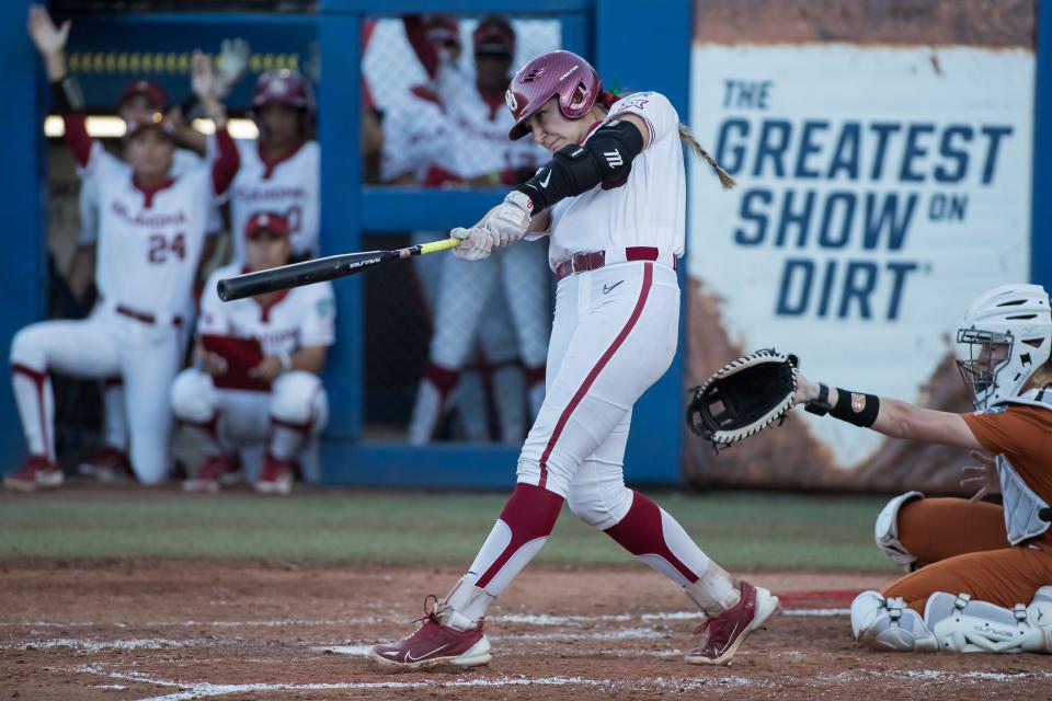 Jun 5, 2024; Oklahoma City, OK, USA; Oklahoma Sooners catcher Kinzie Hansen (9) hits a two run home run in the third inning against the Texas Longhorns during game one of the Women's College World Series softball championship finals at Devon Park. Mandatory Credit: Brett Rojo-USA TODAY Sports