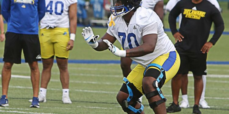 Offensive Lineman Anwar O'neal simulates blocking a defender during the first day of practice for the University of Delaware football team on Tuesday July 30, 2024.