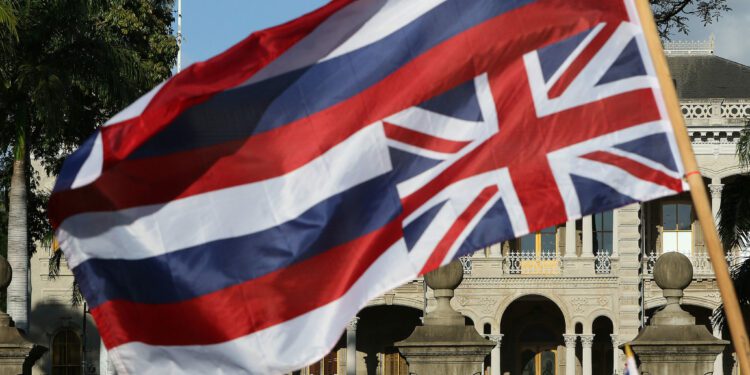 Demonstrators wave an upside down Hawaiian Flag along King Street near Iolani Palace.