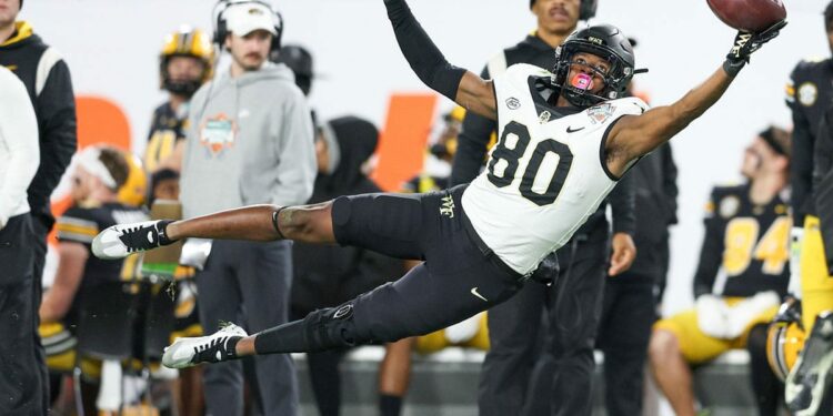 Wake Forest Demon Deacons wide receiver Jahmal Banks (80)(80) leaps for a pass against the Missouri Tigers in the second quarter in the 2022 Gasparilla Bowl at Raymond James Stadium.