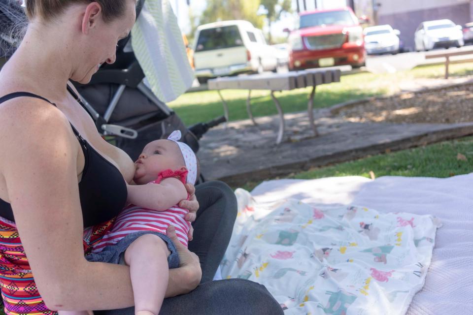 Darby Cline with her 4 month old baby Zaliyah Jewell-borquez, feeding breast milk while several moms came to support Nationwide Nurse-In Arizona 2019 at Rose Garden beside Arizona State Capitol on April 26, 2019.