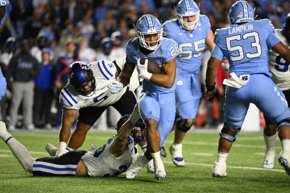 Nov 11, 2023; Chapel Hill, North Carolina, USA; North Carolina Tar Heels running back Omarion Hampton (28) with the ball as Duke Blue Devils linebacker Nick Morris Jr. (36) defends in the first quarter at Kenan Memorial Stadium. Mandatory Credit: Bob Donnan-USA TODAY Sports