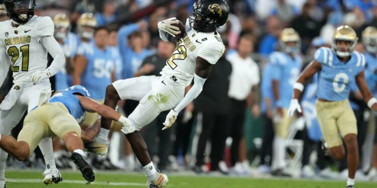 Colorado cornerback Travis Hunter (12) intercepts a pass against UCLA in the first half at Rose Bowl.