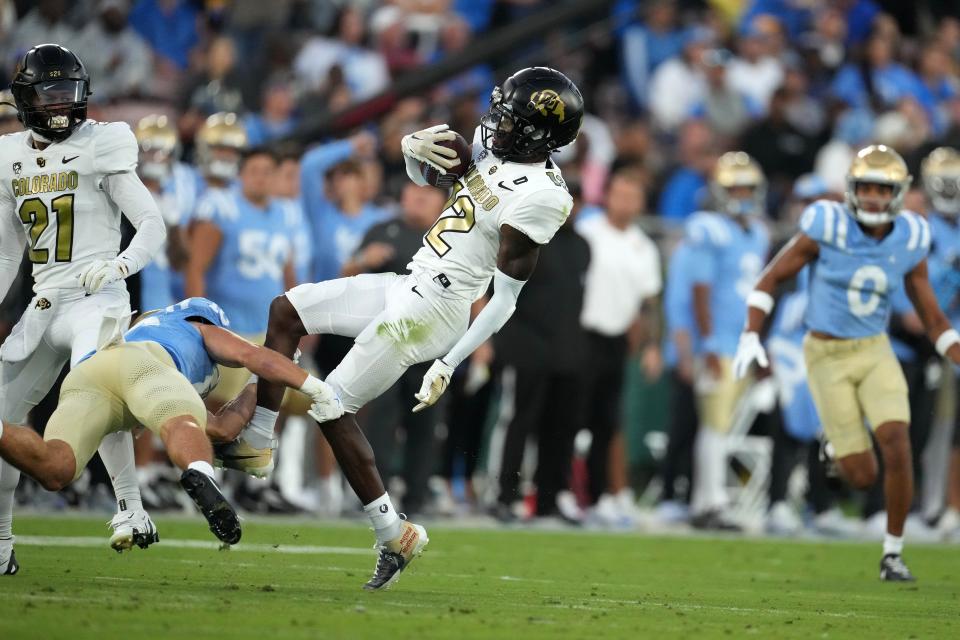 Colorado cornerback Travis Hunter (12) intercepts a pass against UCLA in the first half at Rose Bowl.