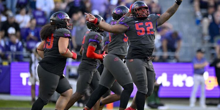 TCU Horned Frogs defensive lineman Damonic Williams (52) and the Frogs defense celebrate after making a defensive stop against the Baylor Bears during the second half at Amon G. Carter Stadium.