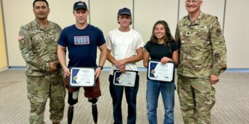 Olympians pose for a photo at Fort Greely, Alaska, during their USO-organized tour of Alaska military installations.