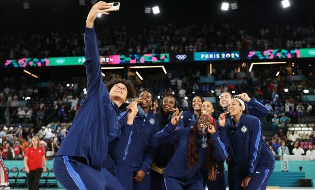 Gold medalist Brittney Griner of Team United States takes a photo with teammates during the Women's basketball medal ceremony on day sixteen of the Olympic Games Paris 2024 at Bercy Arena on August 11, 2024 in Paris, France. (Photo by Gregory Shamus/Getty Images)