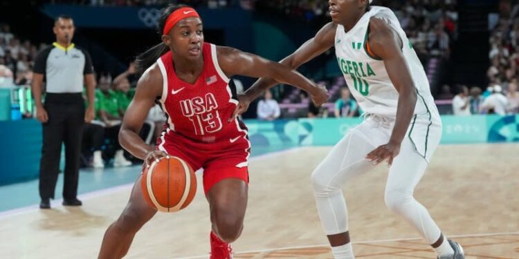 Team USA guard Jackie Young (L) drives to the net past Promise Amukamara of Nigeria during a Summer Olympics women's basketball quarterfinal Wednesday in Paris. Photo by Richard Ellis/UPI