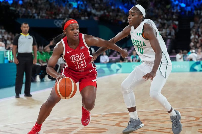 Team USA guard Jackie Young (L) drives to the net past Promise Amukamara of Nigeria during a Summer Olympics women's basketball quarterfinal Wednesday in Paris. Photo by Richard Ellis/UPI