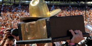 The Golden Hat Trophy is raised after the Red River Rivalry college football game between the University of Oklahoma Sooners (OU) and the University of Texas (UT) Longhorns at the Cotton Bowl in Dallas, Saturday, Oct. 7, 2023. Oklahoma won 34-30.