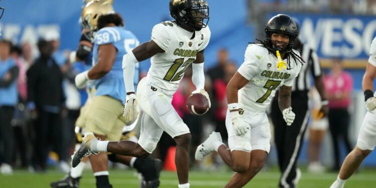 Oct 28, 2023; Pasadena, California, USA; Colorado Buffaloes cornerback Travis Hunter (12) celebrates after intercepting a pass against the UCLA Bruins in the first half at Rose Bowl. Mandatory Credit: Kirby Lee-USA TODAY Sports