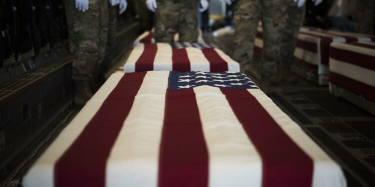 U.S. service members assigned to the Defense POW/MIA Accounting Agency stand by before a solemn movement ceremony at Joint Base Pearl Harbor-Hickam, Hawaii, in January 2018. The ceremony honored personnel lost in the Philippines during World War II.