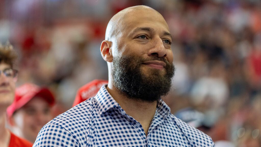 Royce White, candidate for U.S. Senate, listens as Republican presidential candidate former President Donald Trump speaks at a campaign rally, Saturday, July 27, 2024, in St. Cloud, Minn.