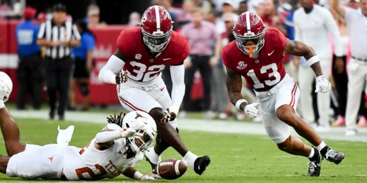 Sep 9, 2023; Tuscaloosa, Alabama, USA; Texas Longhorns running back Jonathon Brooks (24) reaches out for the ball as Alabama Crimson Tide linebacker Deontae Lawson (32) and Alabama Crimson Tide defensive back Malachi Moore (13) close at Bryant-Denny Stadium. The pass was ruled incomplete. Mandatory Credit: Gary Cosby Jr. -USA TODAY Sports