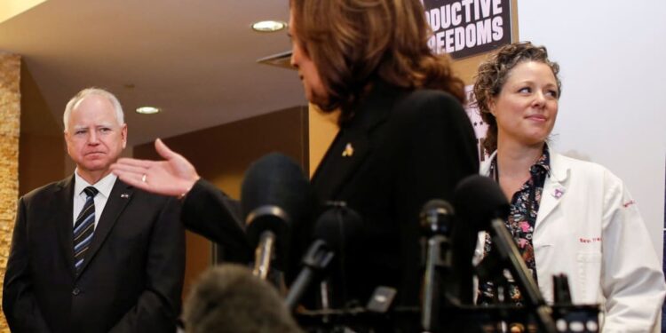 Vice President Kamala Harris speaks next to Minnesota Gov. Tim Walz during a visit to the St. Paul Health Center in St. Paul, Minnesota on March 14, 2024