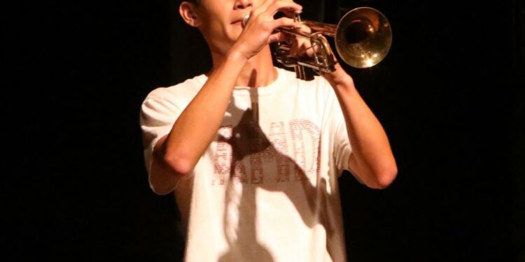 Senior Jonathan Kang plays trumpet during the marching band's performance at the back to school staff assembly at Ossining High School Aug. 28, 2024. The Ossining High School's marching band has been invited to perform in the Pearl Harbor Memorial Parade in Hawaii on December 7, 2024.