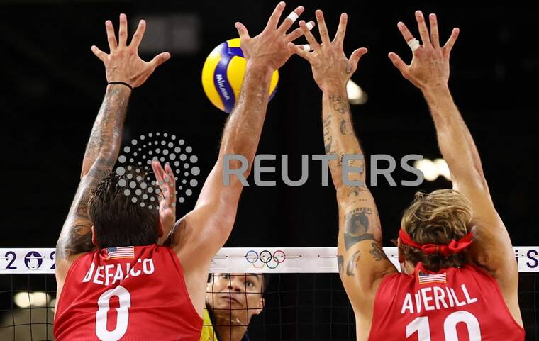 REUTERS/SIPHIWE SIBEKO
                                Darlan Ferreira Souza of Brazil in action with Torey Defalco and Taylor Averill of United States in the Mens volleyball Quarterfinals at the 2024 Paris Olympics today.