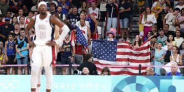 Fans wave an American flag at Team USA's basketball game vs. South Sudan.