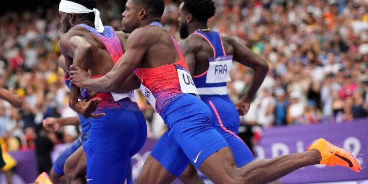 Christian Coleman, right, of the United States, struggles to hand the baton to teammate...