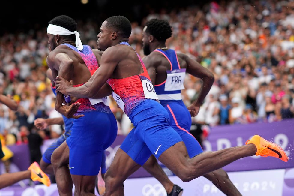 Christian Coleman, right, of the United States, struggles to hand the baton to teammate...