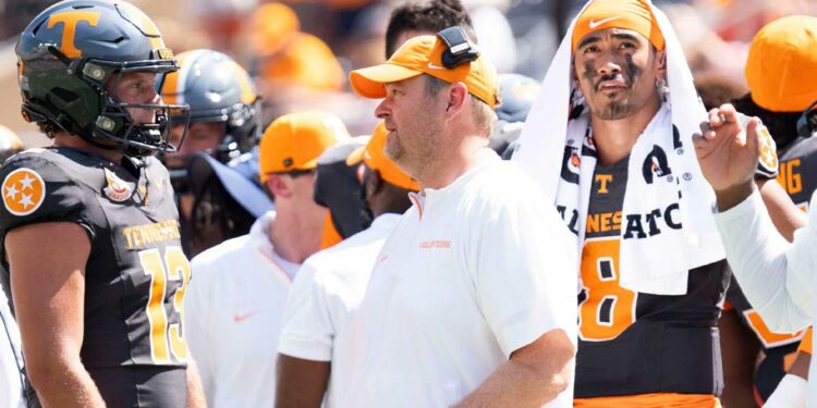 Tennessee head coach Josh Heupel speaks with Tennessee quarterback Gaston Moore (13) with Tennessee quarterback Nico Iamaleava (8) behind him, during a game between Tennessee and Chattanooga, Saturday, Aug. 31, 2024.