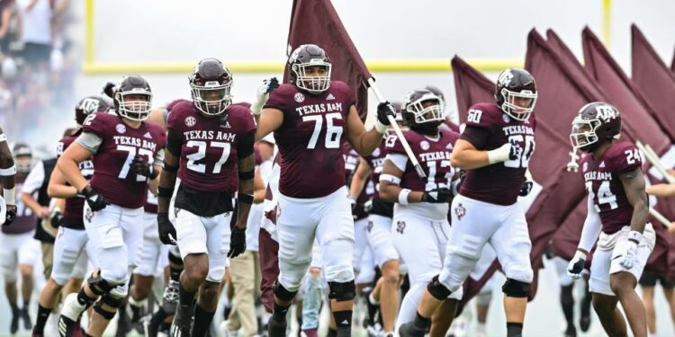 Sep 3, 2022; College Station, Texas, USA; Texas A&M Aggies offensive lineman Reuben Fatheree II (76) carries the flag as he runs out prior to the game against the Sam Houston State Bearkats at Kyle Field. Mandatory Credit: Maria Lysaker-USA TODAY Sports